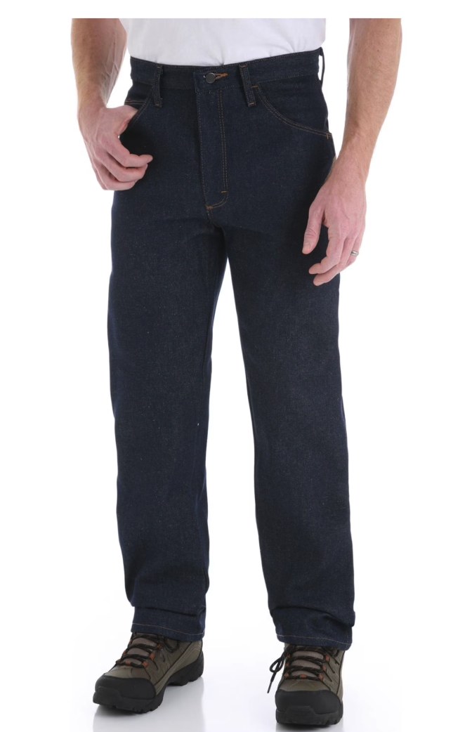 Man wearing Rustler dark indigo straight leg jeans with a white t-shirt and hiking boots, front view