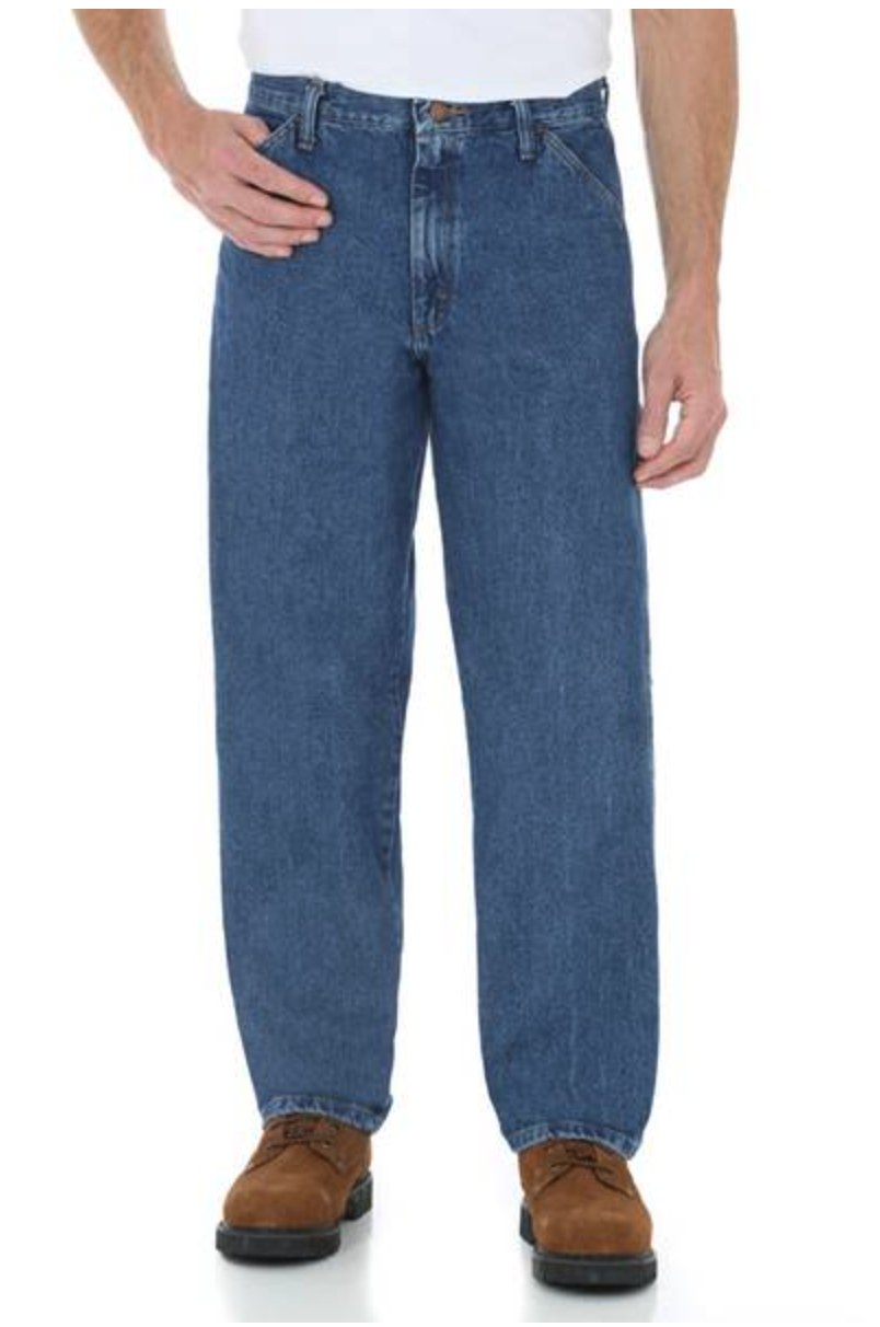 Man wearing Rustler baggy fit medium stonewash jeans with a white t-shirt and tan work boots, front view
